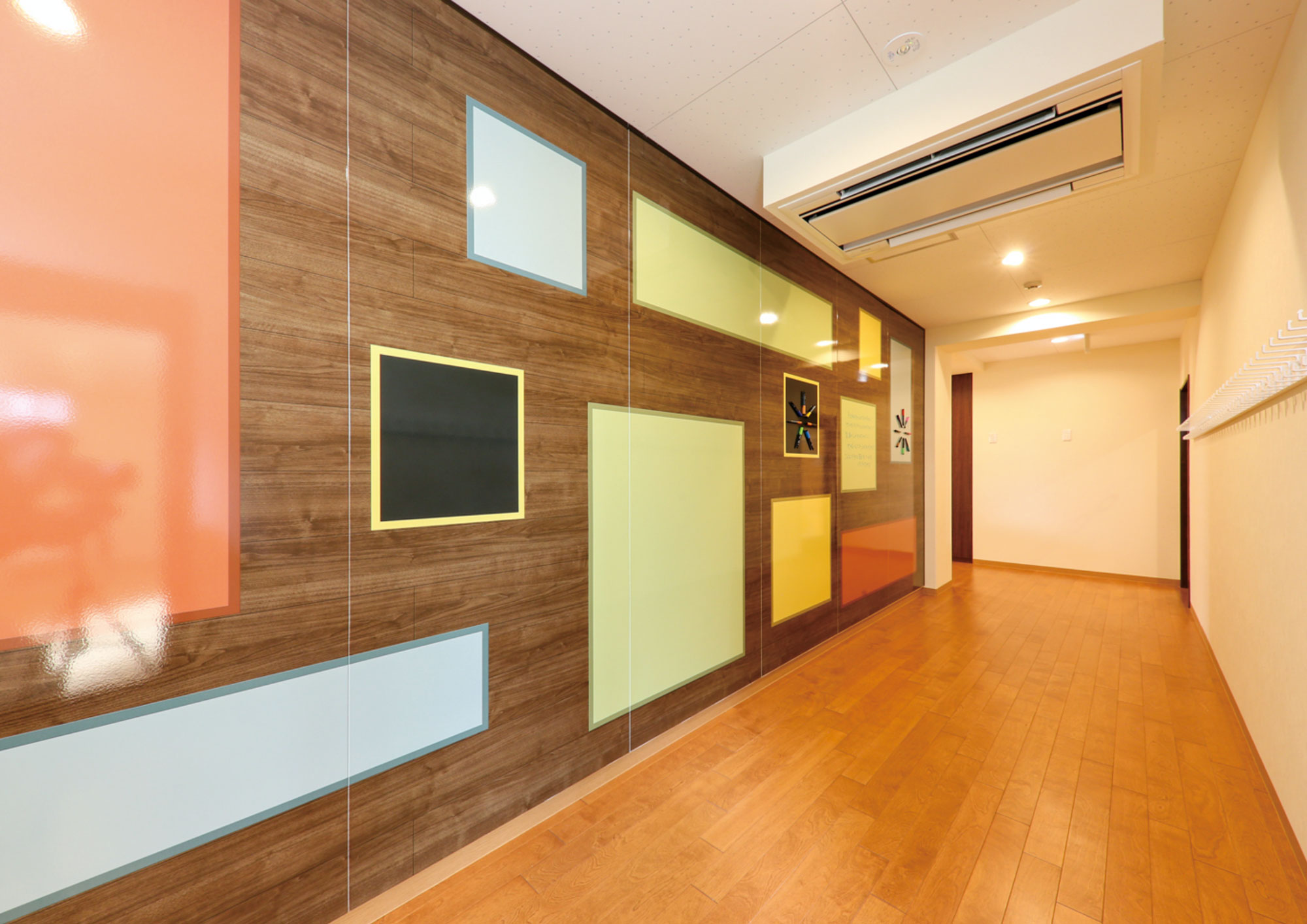 Cocoro Lab corridor with colourful geometric wall panels
