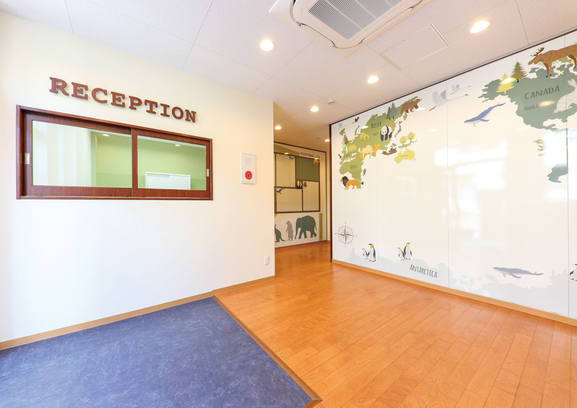 Cocoro Lab reception with an illustrated world map wall